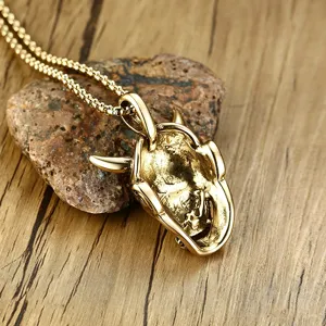 Detailed macro view of vintage gold Hannya ghost mask pendant in titanium steel.