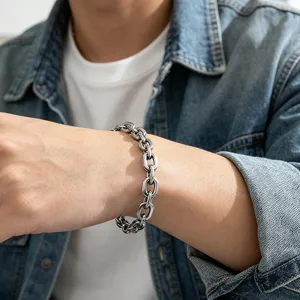 Close-up of a minimalist chunky stainless steel chain bracelet worn by a male model