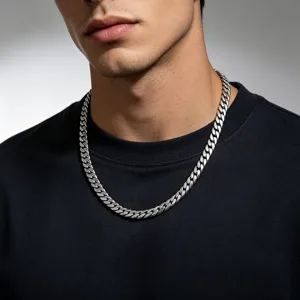 Detail view of a men's polished stainless steel flat Cuban link necklace on a model.