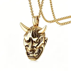 Detailed view of a vintage gold Hannya mask pendant on a sturdy box chain for men