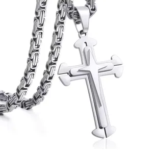 Close-up detail of a multi-layered silver stainless steel cross pendant with chain.