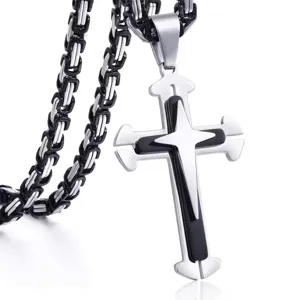 Detailed close-up showing the texture of a two-tone stainless steel cross pendant.