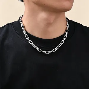 Close-up of glossy silver stainless steel paperclip chain necklace on a male model