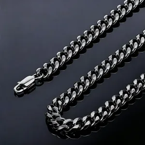 Detailed macro shot of a thick black polished titanium steel Cuban link chain jewelry