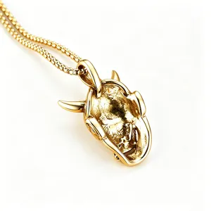 Detailed macro view of gold-plated titanium steel Hannya mask pendant on a box chain