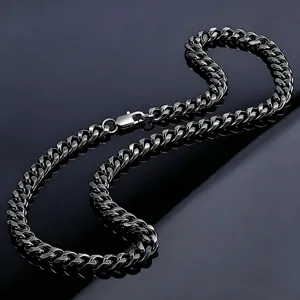 Macro detail of a thick black polished Cuban link chain with a secure lobster clasp.