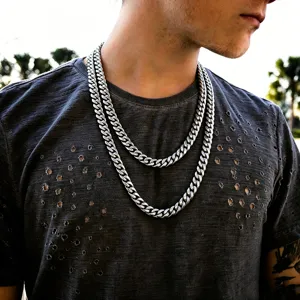 Detail view of layered thick silver Cuban link necklaces for men in hip hop style