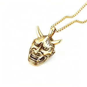 Detailed view of the gold-colored retro Hannya Oni mask pendant attached to a box chain