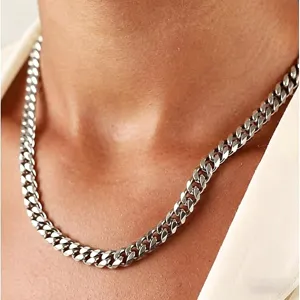 Detailed close-up view of a polished silver Cuban link chain necklace in hip hop style