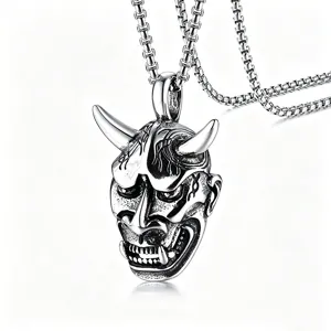Close-up detail of retro stainless steel Hannya mask pendant for a hip-hop men's necklace.