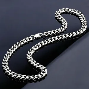 Macro view of high-polished silver Cuban link chain with a secure lobster clasp