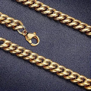 Close-up of gold plated stainless steel Cuban link necklace with lobster clasp.