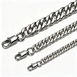 Detailed view of three stainless steel Cuban link chains in varying widths