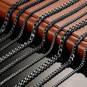 Detailed macro view of black stainless steel Cuban link chains in various widths.