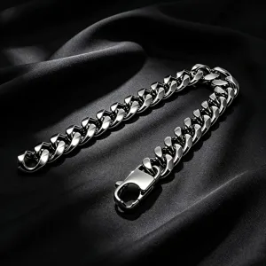 Close-up of thick silver stainless steel Cuban link bracelet on black silk background