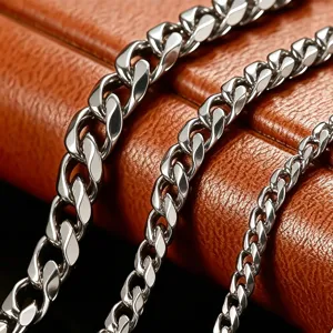 Close-up detail of silver titanium steel Cuban link chains in three different widths