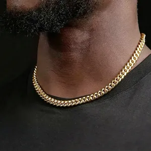 Detailed macro shot of a masculine 18K gold-plated thick Cuban link chain necklace