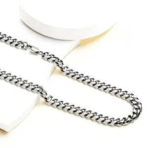 Close-up detail of a polished silver titanium steel chunky Cuban link chain necklace