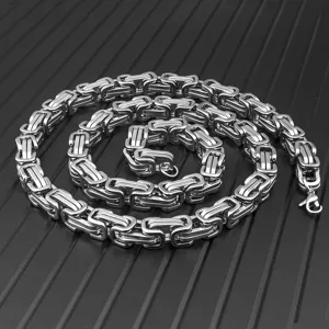Detailed macro view showing the intricate texture of a silver Byzantine stainless steel chain