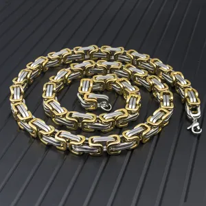Macro detail of men's two-tone gold and silver stainless steel Byzantine chain bracelet