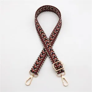 Detail of woven replacement strap with geometric pattern and golden metal hardware