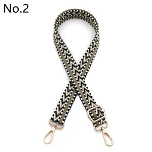 Close-up detail of the woven chevron pattern bag strap with adjustable gold metal hardware