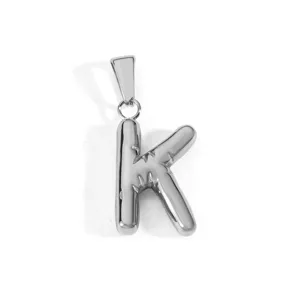 Detailed macro shot of a shiny polished stainless steel bubble initial letter K pendant