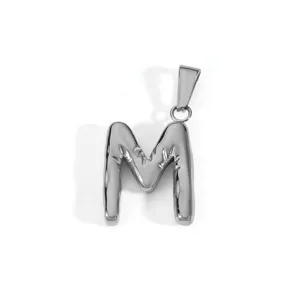 Close-up of a textured silver stainless steel capital letter M pendant with bail