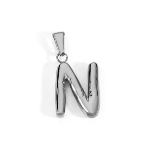 Detail view of a polished stainless steel uppercase letter N pendant accessory.
