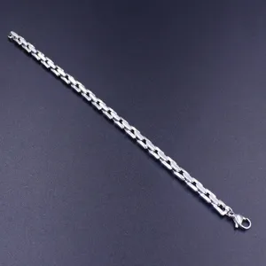 Detail view of a polished stainless steel bamboo tank chain bracelet with lobster clasp.