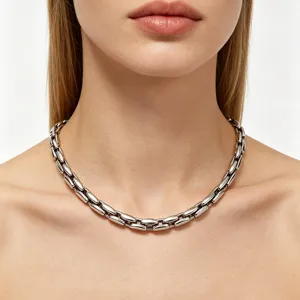 Close-up detail of a minimalist polished titanium steel tank chain necklace on a model