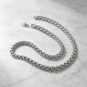 Close-up macro detail of polished stainless steel wheat chain with secure lobster clasp