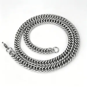 Macro detail view of a heavy double-woven stainless steel Cuban link chain in silver