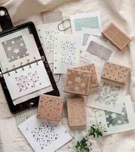 Detailed view of beech wood stamps with star and floral patterns for creative journaling