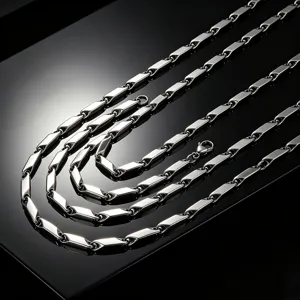 Close-up of a silver stainless steel rhombic link necklace on a reflective surface.