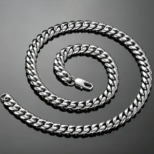 Detailed macro view of a polished stainless steel Cuban link necklace with a lobster clasp