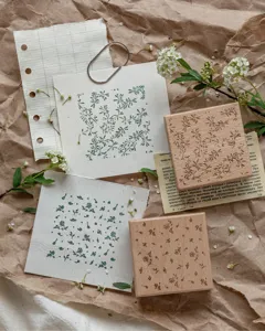 Detailed view of square beech wood stamps with floral and leaf patterns for journaling