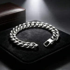 Close-up of a polished stainless steel Cuban link bracelet on a black velvet stand