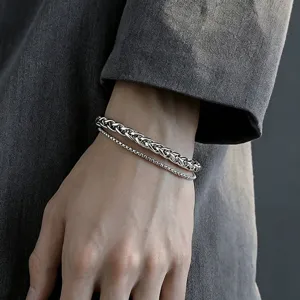 Detailed close-up view of double layered silver stainless steel wheat chain bracelet for men