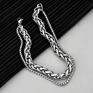 Detailed close-up of a double-layered stainless steel Cuban and box chain bracelet
