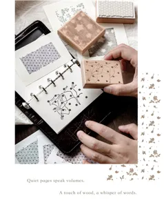 Detailed macro view of a creative wooden stamp being pressed onto a notebook page