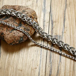 Detailed macro view of silver double-layer stainless steel Cuban link and box chain bracelet