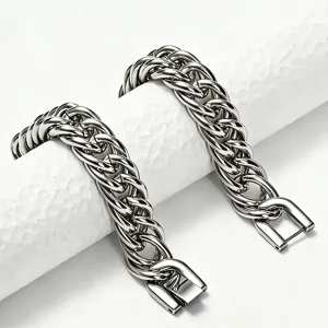 Close-up macro detail of heavy stainless steel Cuban link bracelet with square clasp design