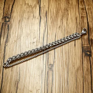 Close-up detail of silver stainless steel double-layer Cuban and box chain bracelet for men