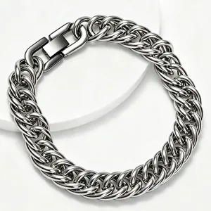 Macro view of polished stainless steel wide Cuban link bracelet with a secure square clasp