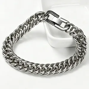 Close-up of a heavy silver-toned stainless steel Cuban link bracelet with a square clasp.