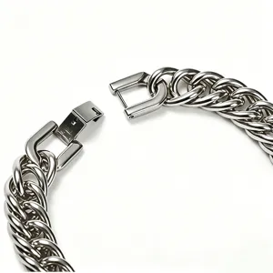 Detailed macro view of a heavy stainless steel Cuban link chain with a square buckle.