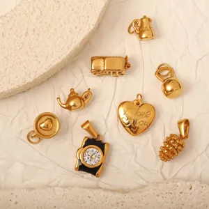 Detailed view of 18k gold plated stainless steel charms including camera and heart shapes