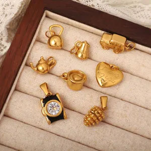 Collection of 18k gold plated stainless steel object charms in jewelry box display