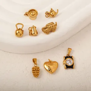 Detailed view of 18k gold plated stainless steel charms in various unique item shapes